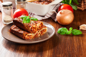 Baked cannelloni with minced meat and bechamel sauce on a plate