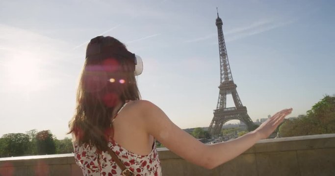 Tourist woman at Eiffel tower Paris wearing virtual reality headset watching 360 video imagination concept