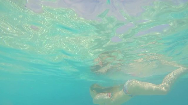 Beautiful woman swimming underwater on paradise beach freedom wellbeing lifestyle summer vacation wanderlust 