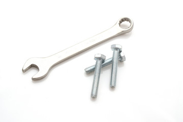 Three bolts And the key isolated on white background. Industry abstraction. A photo for your store.