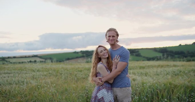 Portrait of authentic couple real people posing for photograph outdoors in nature slow motion