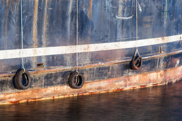 side of ship with tires as bumpers