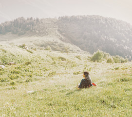 Woman resting on mountain meadow
