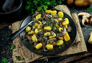 Home made potato gnocchi with mushrooms, chopped parsley and parmesan cheese