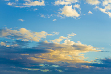 Fototapeta premium white fluffy clouds in the blue sky with sunset.