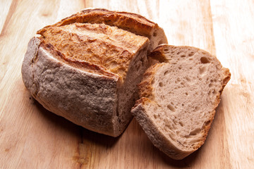 Rustic bread on an wooden table. Country house style. Authentically.