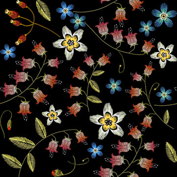 Beautiful spring flowers on black background. Classical embroidery fashionable template for design of clothes. Cornflowers embroidery seamless pattern