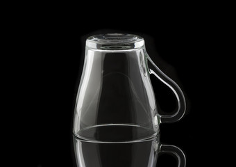 Empty glass cup on a black background