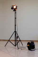 Spotlight with halogen bulb and Fresnel lens. Lighting equipment for Studio photography or...