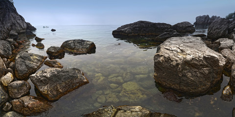 Summer foggy morning on the sea shore