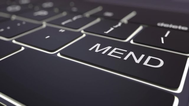 Dolly shot of black luminous computer keyboard and mend key. Conceptual 4K clip