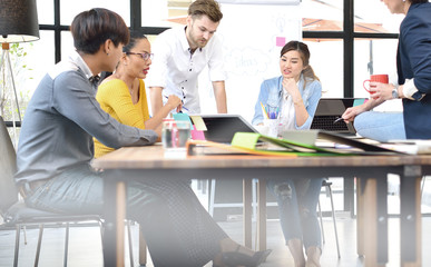 Group of businesspersons having different age in creative business discussing work in the office
