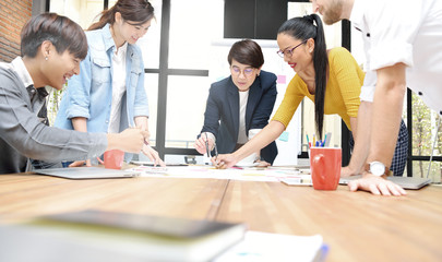 Group of businesspersons having different age in creative business discussing work in the office