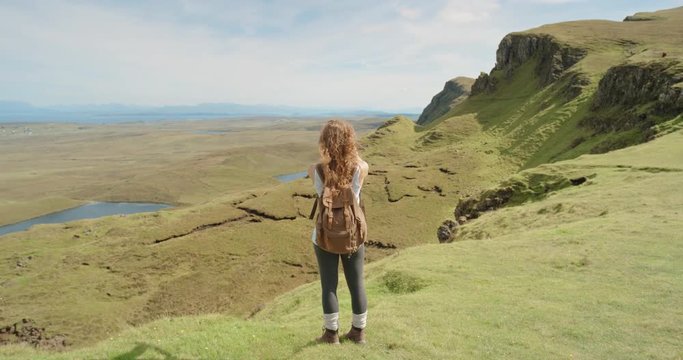 Hiker Woman taking photograph smartphone photographing scenic landscape nature background view enjoying vacation travel adventure. Quiraing Walk on the Isle of Skye in Scotland
