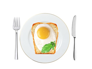 Scrambled eggs with bread and basil on plate isolated on white