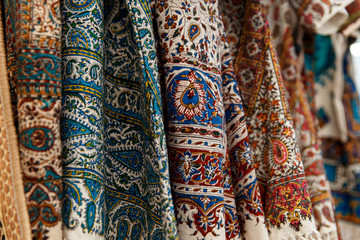 Many colorful carpets for sale on a street