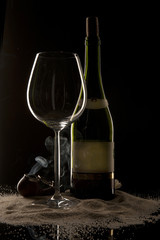 A bottle of a glass and a smoking pipe