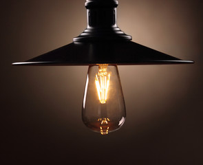 Industrial pendant lamps against wall. Loft interior. Edison bulbs.