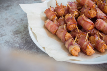 Deep fried sausages rolled in bacon