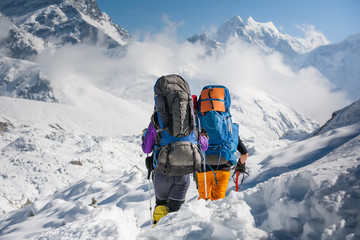 Trekkers crossing Gokyo glacier in Khumbu valley on a way to Everest Base camp - obrazy, fototapety, plakaty