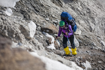 Trekkers crossing Gokyo glacier in Khumbu valley on a way to Everest Base camp