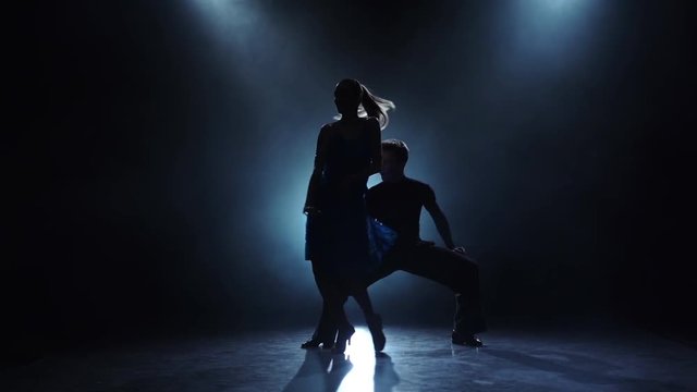 Dance salsa performed by a professional couple in slow motion