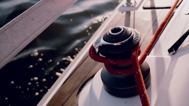 Close-up view of man using the capstan head to fixing the rope. Sailor using capstan drum, the crew steers the ship.