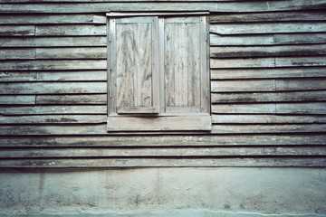 Old wooden window on a wooden wall  texture background