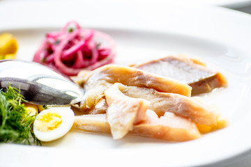 Herring sliced with red onions and boiled potatoes.