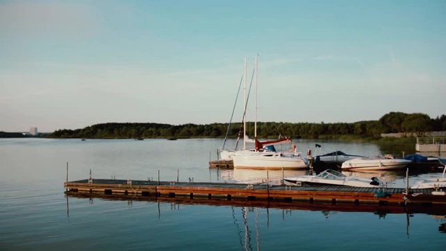 Old wooden mooring in the morning. Speed ships standing near the the pire. Beautiful nature landscape.