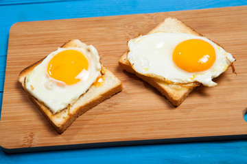 Toasts and egg on a blue wooden table