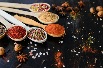 Various spices on wooden spoons. Food ingredients