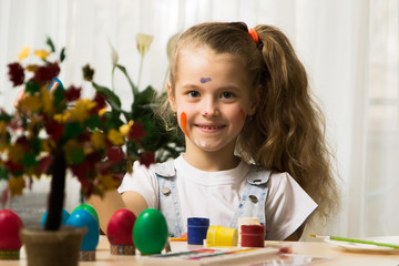 Caucasian girl kid draw eggs before easter holiday