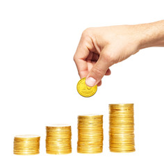 Savings, increasing columns of gold coins and man hand