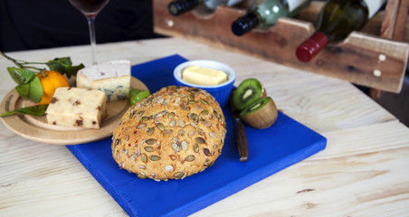 Whole crusty loaf, with wine and cheese focus on front.