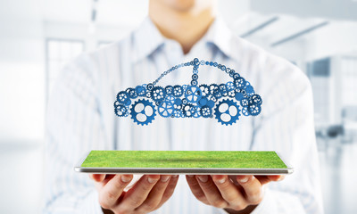 Close of businessman holding tablet pc with car icon on screen