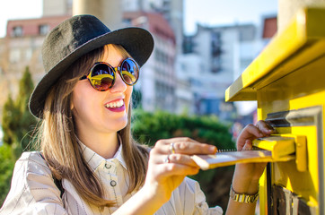 Girl inserting letter into a mailbox