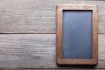 Fototapeta premium old school blackboard on a background of blackened wood panels