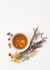 Obraz na płótnie Canvas Herbal tea and dried herbs on a white background