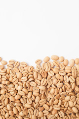 Grains of green coffee on a white background