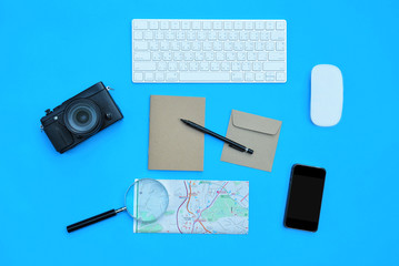 Flat lay of accessories on blue desk background