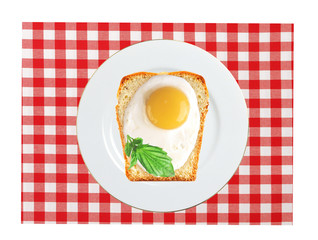 Scrambled eggs with bread on plate, on color napkin