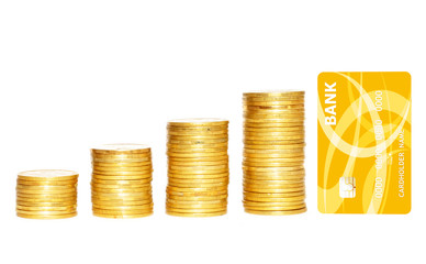 columns of gold coins and golden credit card isolated on white background