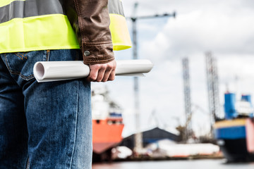 Shipbuilding engineer holding construction documents.