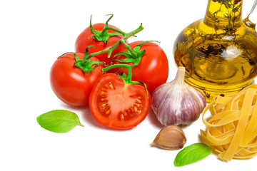Fresh tomatoes, garlic, pasta and olive oil isolated on white background
