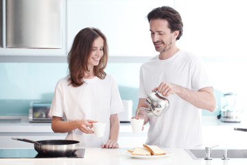 Couple cooking breakfast