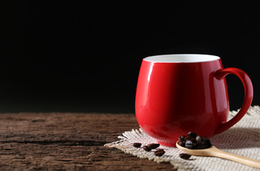 Red Coffee Cup and Coffee Bean on the old wood table with copy space for your text