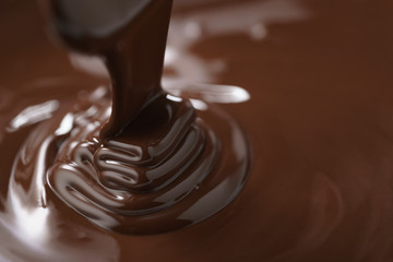macro photo of premium dark chocolate pour in bowl, shallow focus