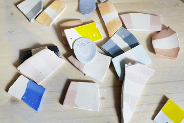 Samples of colored enamel for ceramics, ceramic pieces, workshop in studio, hand-craft work