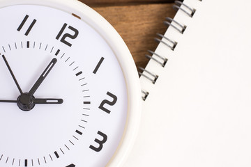 Close up white clock on wood texture background